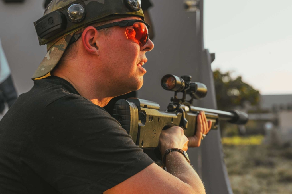 A sniper pausing to talk with his team in tactical laser tag