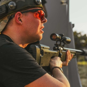 A sniper pausing to talk with his team in tactical laser tag